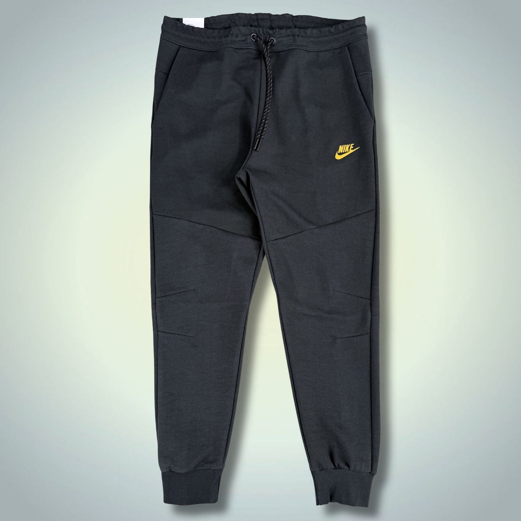 Nike Tech Fleece męskie sportowe spodnie, grafitowe, żółte logo. Premium jakość